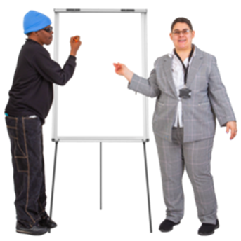 Two people - a man and a woman - standing in front of a flip chart. The man is wearing a blue hat. The woman wears a grey suit.