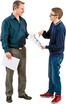 Two men discussing the bits of paper they are holding