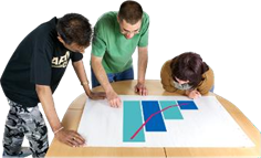 Group of three looking at graph on a table