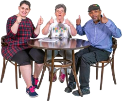Three people around a table with their thumbs up