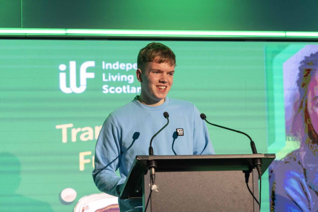 Young man speaking at a podium.