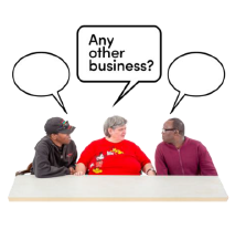 Three people behind a desk with speech bubbles above their heads. The middle bubble reads 'Any Other Business?