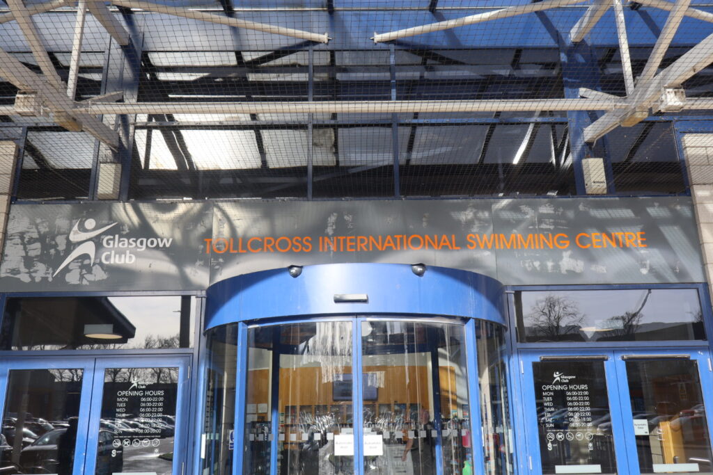 Front door of the Tollcross International Swimming Centre in Glasgow on a sunny day.