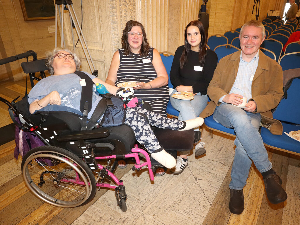 A family pose for a photograph - all seated.