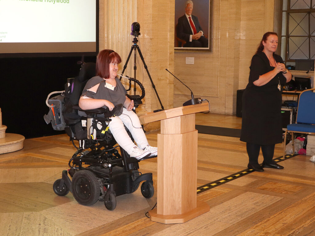 A young lady sits at the podium.