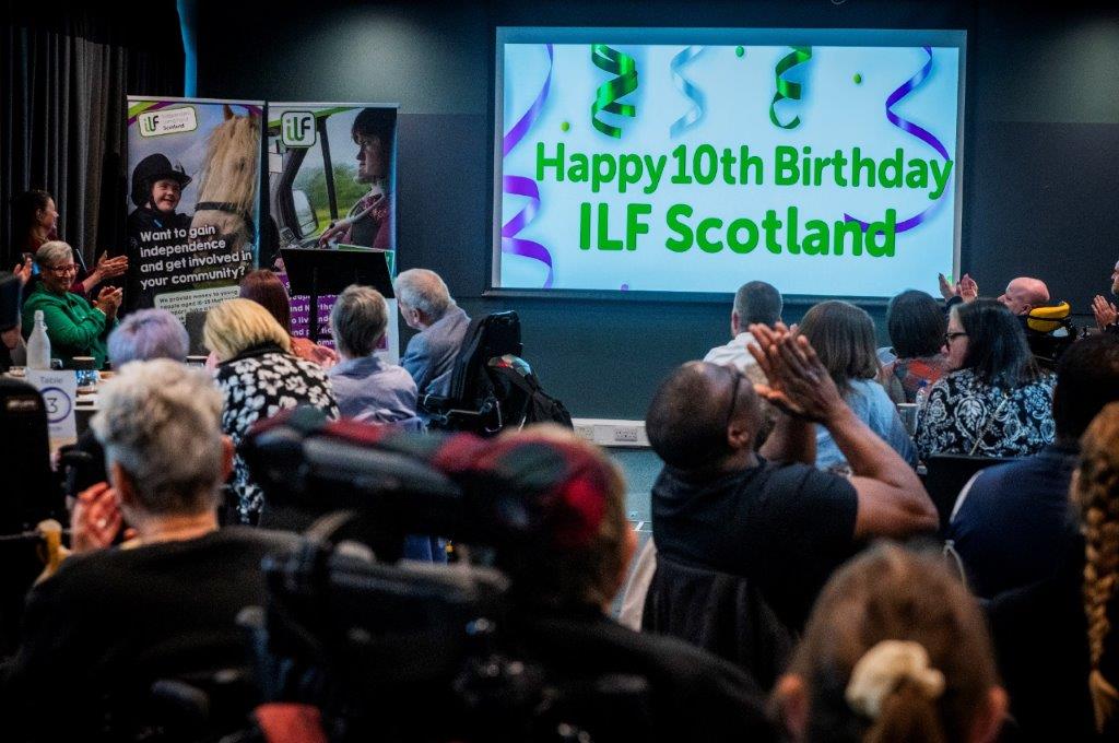 Shot of the event room with the presentation screen that reads Happy 10th Birthday ILF Scotland.
