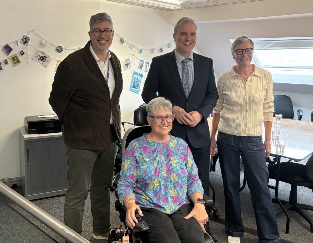4 people posing for a photograph - all smiling for the camera.