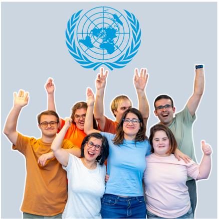 A group of smiling young people with their hands in the air. The UN logo sits above them.