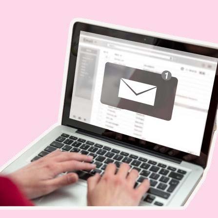 Email on a laptop computer screen with hands on the keyboard. The email is shown as an envelope.
