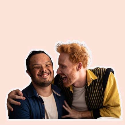A man with protective arms around another man and they are both laughing.