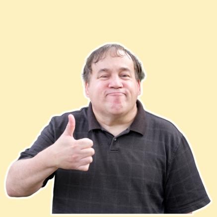 A smiling man giving a thumbs up on a yellow background.