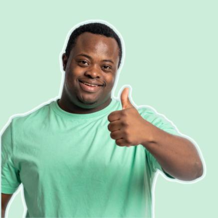 A smiling black man in green giving the thumbs up.
