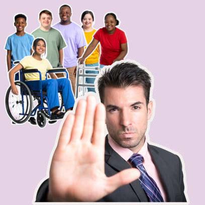 Man in a suit with his hand in a stop gesture while a group of disabled people are behind him.