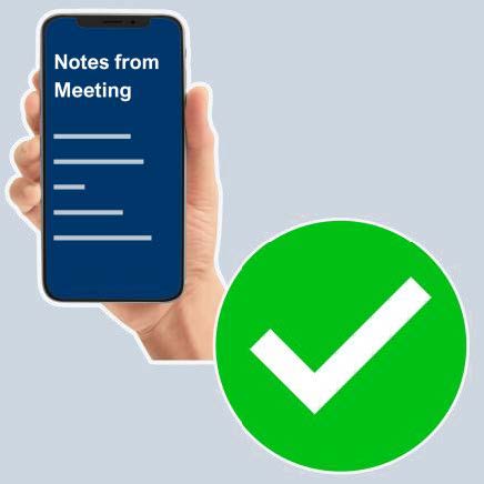 A hand holding a mobile phone showing notes from a meeting on the screen. A big green tick is next to it.