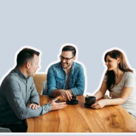 Three people sitting at a table with coffee