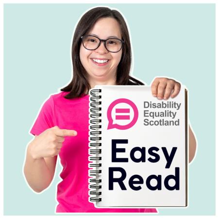 A smiling woman holding a document with the title 'Easy Read' on the cover along with the DES logo.