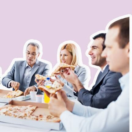 People enjoying a pizza party while sitting round a table.