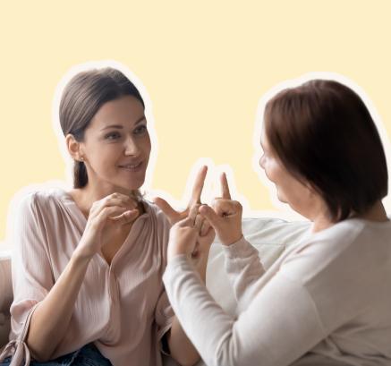 Two women doing sign language (BSL) together.